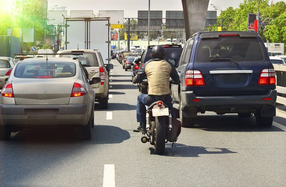 Motorcycle rider about to engage in lane splitting traffic.