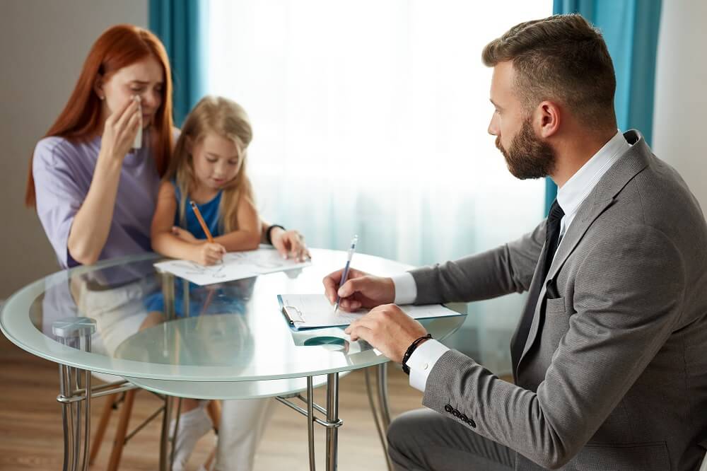 Crying mother with child seeking advise for wrongful death case.
