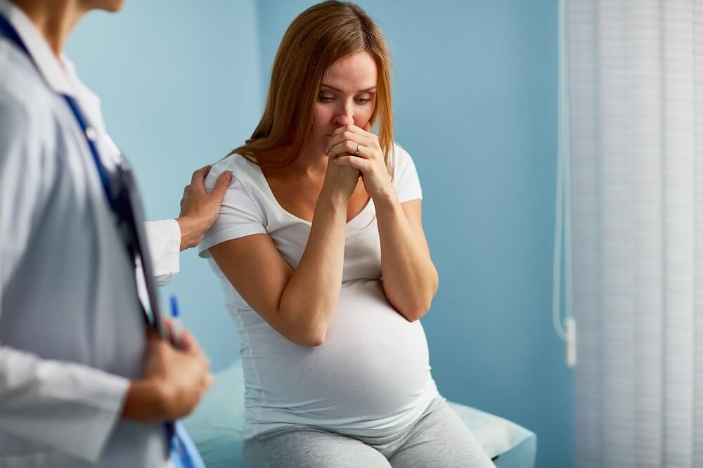 Worried pregnant consulting her doctor for check-up